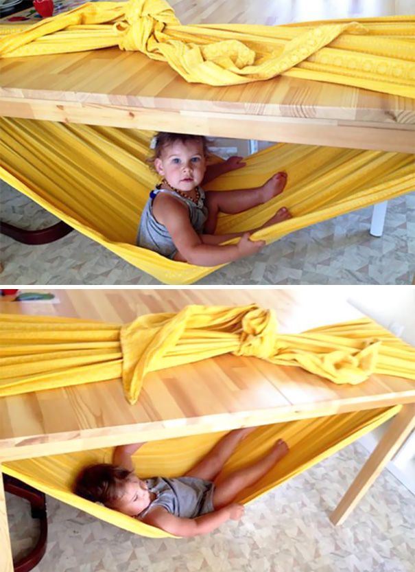 a child is laying in a hammock with a yellow blanket