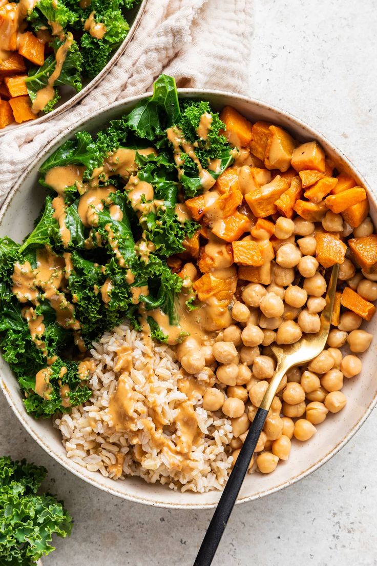 two bowls filled with rice, chickpeas and broccoli