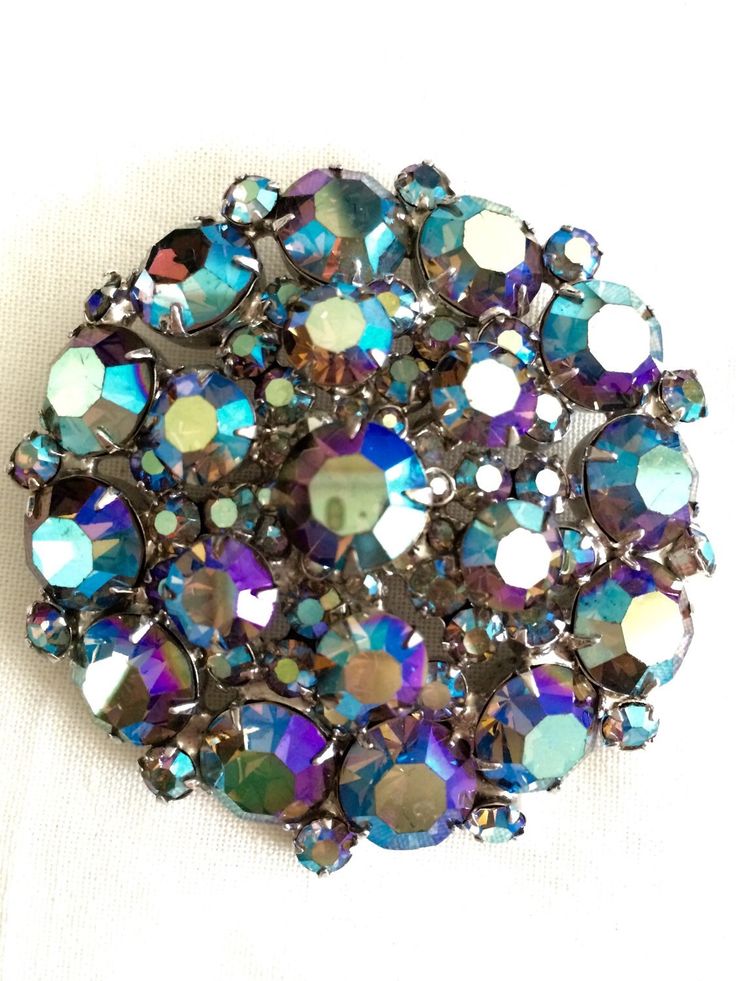 SALE! Original price $125.95 This came from a Hollywood estate of a most stylish woman. Brilliant, glittering AB peacock rhinestone brooch is dazzling. Confirmed D&E Juliana.  Look closely at the photo of the back. The figure 8s are clear, the solid rivets and cup mount are all signs of real D&E.  This is a statement piece you will love for years to come.  One of the photos shows the sparkle reflecting off the brooch onto my ceiling. It's all over the room. Amazing brilliance. Excellent condition.  MEASUREMENT:  2.5" Thank you for looking. I am most grateful. Please check in often for new and interesting items.  You never know what might turn up.  Free shipping via 1st class in continental US on purchases over $35.  Express shipping is available. Please contact me prior to making payment. Juliana Jewelry, Rhinestone Costumes, Enamel Art, Jewelry Knowledge, Vintage Rhinestone Jewelry, Vintage Jewlery, Vintage Girls Dresses, Vintage Rhinestone Brooch, Jewelry Antique