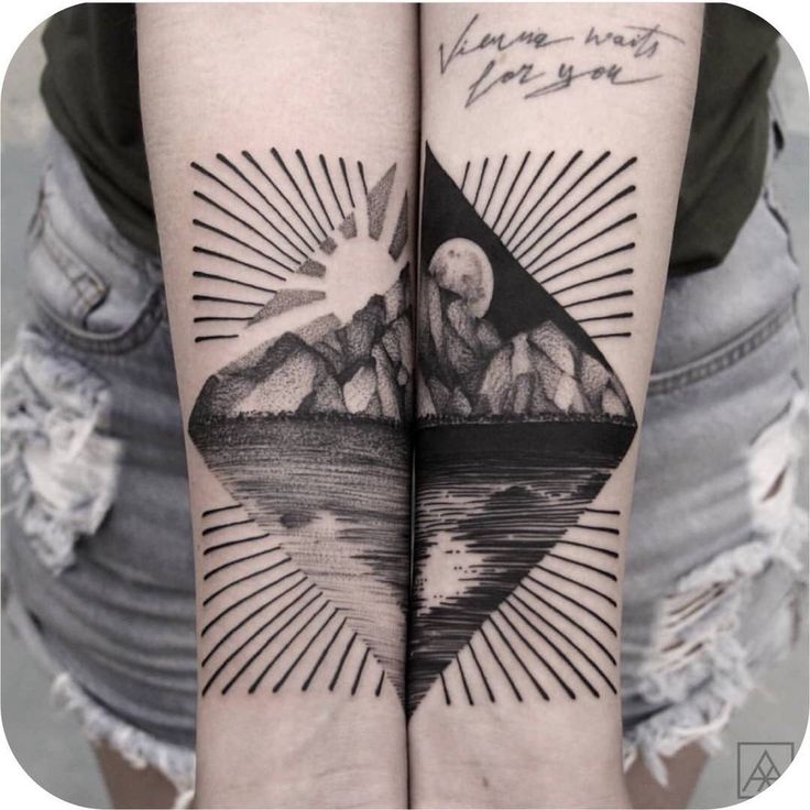 two tattoos on both arms with mountains in the background and sun rays coming from them