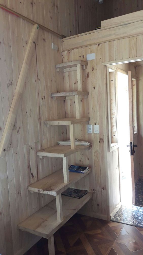 an empty room with wooden walls and shelves