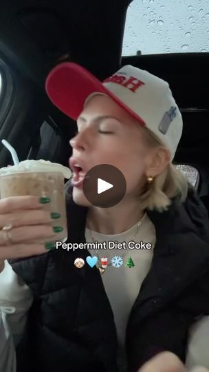 a woman drinking from a cup while sitting in the back of a car with her mouth open