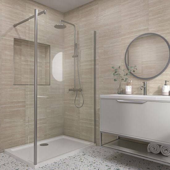 a bathroom with a walk in shower next to a white sink and mirror on the wall