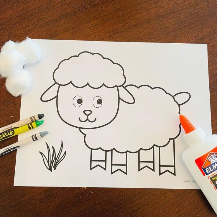 a sheep is shown with crayons on the table next to it and some cotton balls