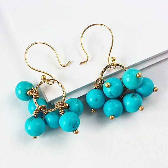 Our line of earrings make wonderful gifts or lovely accessories for your holiday festivities. Understated colors and refined sparkle will complete almost any formal outfit, while looking just as lovely with jeans and a t-shirt.Fashioned from genuine reconstituted turquoise and gold-plated findings, each turquoise drop is made by hand, then gathered together into chic little clusters. Measures 1.25 in/31 mm from top of hook to bottom of drop.Try it with my Turquoise and Freshwater Pearl Pendant:h Elegant Turquoise Beaded Earrings For Gift, Turquoise Jewelry For Party, Nickel-free Turquoise Earrings For Party, Elegant Turquoise Beaded Earrings Nickel-free, Elegant Turquoise Beaded Earrings Nickel Free, Elegant Turquoise Beaded Earrings For Party, Unique Dangle Earrings, Pastel Jewelry, Peridot Earrings