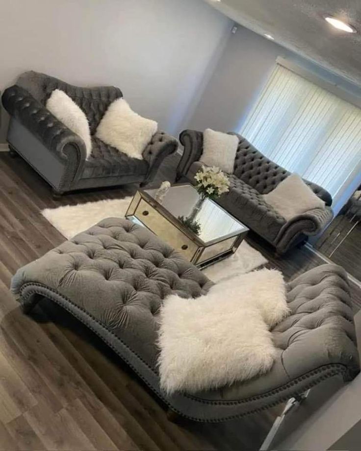 a living room with two couches and a coffee table in the middle of it