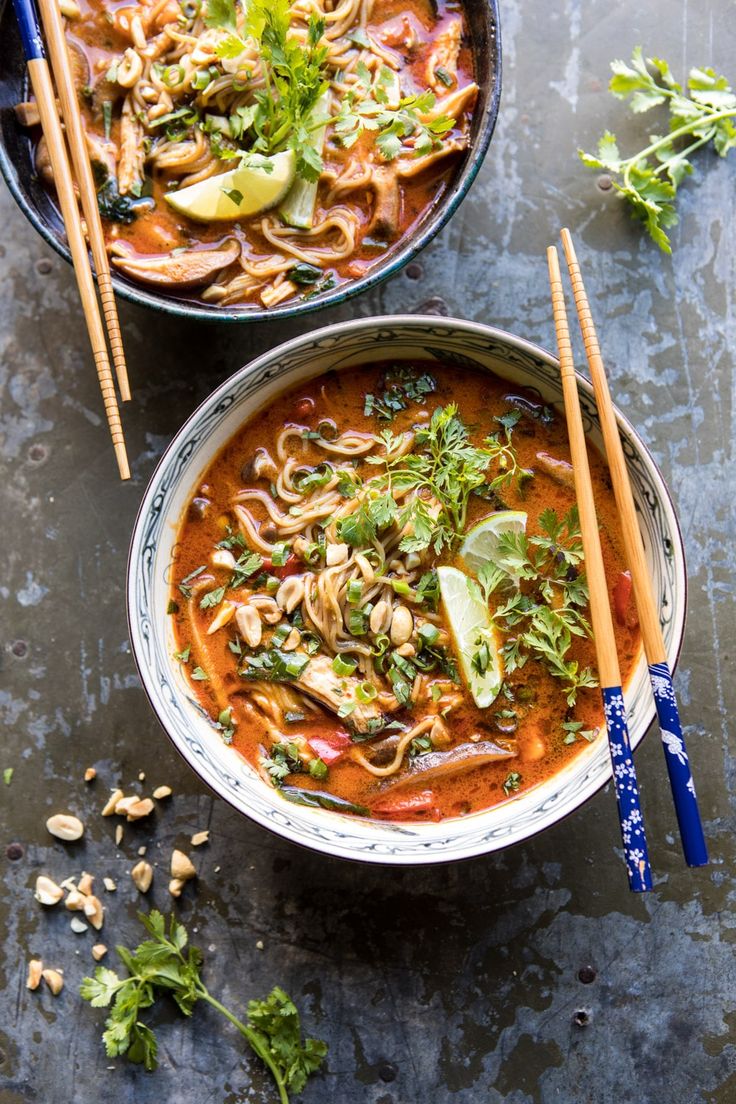 two bowls of soup with chopsticks on the side