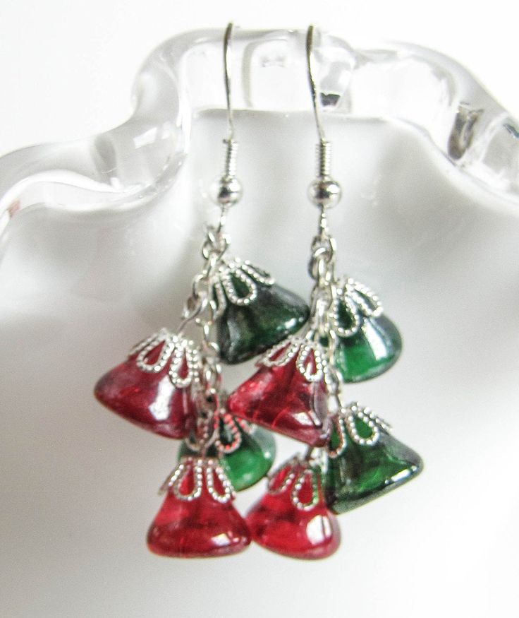 Red and Green Bells hanging from a chain bringing up the Holiday Jingle. Give the Christmas spirit as a gift or keep it for yourself, these earrings will be a great addition to your Christmas sweater . The earrings are 1.75in long (4.5cm) with Surgical Steel fishhook earwire. For larger selection you can visit my shop: http://www.etsy.com/shop/EvaLineJewelry?ref=si_shop Christmas Celebration Jewelry Drop Earrings, Christmas Celebration Drop Earrings Jewelry, Christmas Gift Drop Earrings, Holiday Dangle Earrings With Ear Wire, Holiday Dangle Jewelry With Matching Earrings, Festive Holiday Jewelry With Dangle Shape, Festive Holiday Dangle Jewelry, Holiday Jewelry With Matching Dangle Earrings, Christmas Dangle Jewelry For Celebration