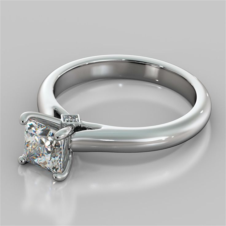 a white gold ring with a princess cut diamond