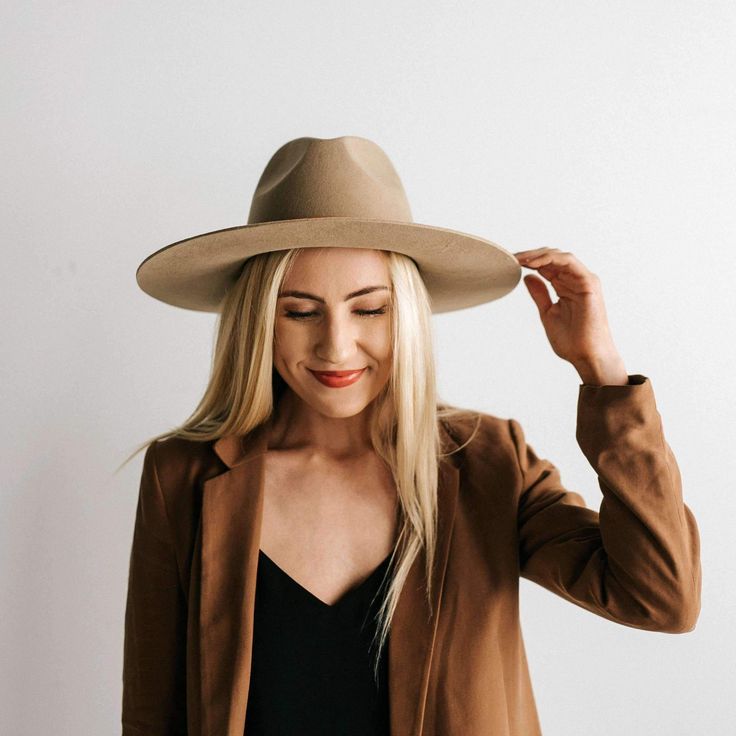 Better than a brilliant neutral? Nothing. The Emma is a classic fedora shape with a stiff A-line shaped brim. Made for versatility, you can customize with any band. Style - Stiff Wide Brim Fedora Material - 100% Australian Wool Dimensions - Crown 10 cm + Brim 10 cm The Emma looks great with our removable leather bands! Bands are sold separately, shop our removable leather bands here. Emma is shown here with our Cognac Removable Band. If you love the Emma, check out Scottie, it's the same hat sty Everyday Leather Fedora With Flat Brim, Fall Fur Felt Hat With Flat Crown, Modern Felt Hat With Flat Brim For Fall, Modern Flat Brim Felt Hat For Fall, Beige Fur Felt Hat For Fall, Classic Brown Felt Hat For Everyday, Modern Felt Hat With Curved Brim For Fall, Modern Curved Brim Felt Hat For Fall, Elegant Leather Felt Hat For Fall