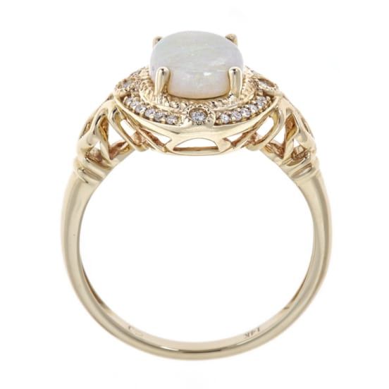 Give her this unique, regal jewelry from Gin & Grace. A colorful display and chic design showcases Natural opal gems and glistening diamonds. The pretty ring is gleaming and made of 14k yellow gold. Gemstone colors: White Gemstone shapes: Oval-cut One prong-set Oval-cut Australian Opal Gemstone weight: 1 5/6 carats Total gemstone weight: 1 1/20 carats Diamonds: 24 Diamond cut: Round Diamond weight: 1/9 carat Color: G-H Clarity: I1-I2 Setting: Prong Metal: 14K Yellow Gold Finish: High polish Luxury Yellow Gold Opal Ring With Gemstone Accents, Luxury Yellow Gold Opal Ring With Accent Stones, Luxury Opal Rings With Gemstone Accents, Luxury Diamond Opal Ring With Gemstone Accents, Luxury Opal Ring With Diamond And Gemstone Accents, Elegant Gold Opal Ring, Formal Opal Ring With Gemstone Accents, Luxury 14k Gold Opal Ring For Anniversary, Elegant 14k Gold Moonstone Ring With Center Stone