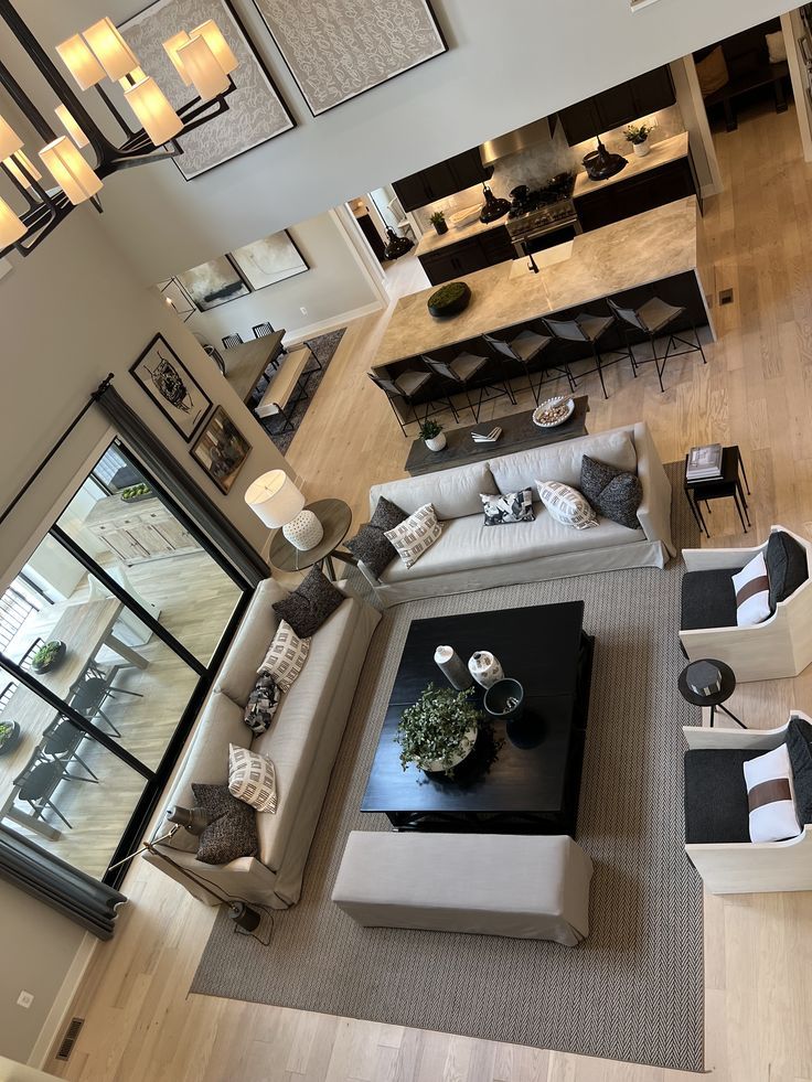 an aerial view of a living room with couches and tables