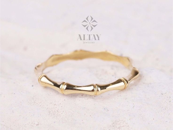 a close up of a gold ring on a white surface