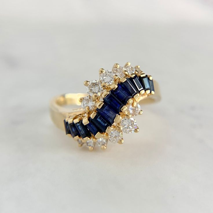 a gold ring with blue and white stones