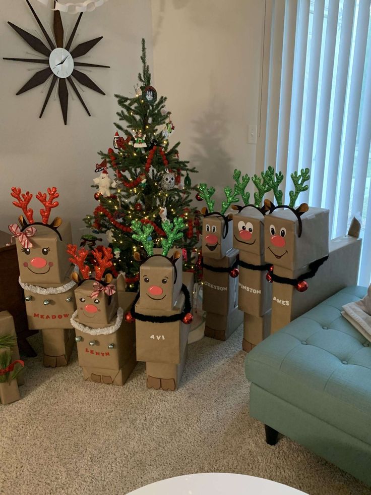 christmas presents are wrapped in brown paper bags with reindeer faces on them, and trees