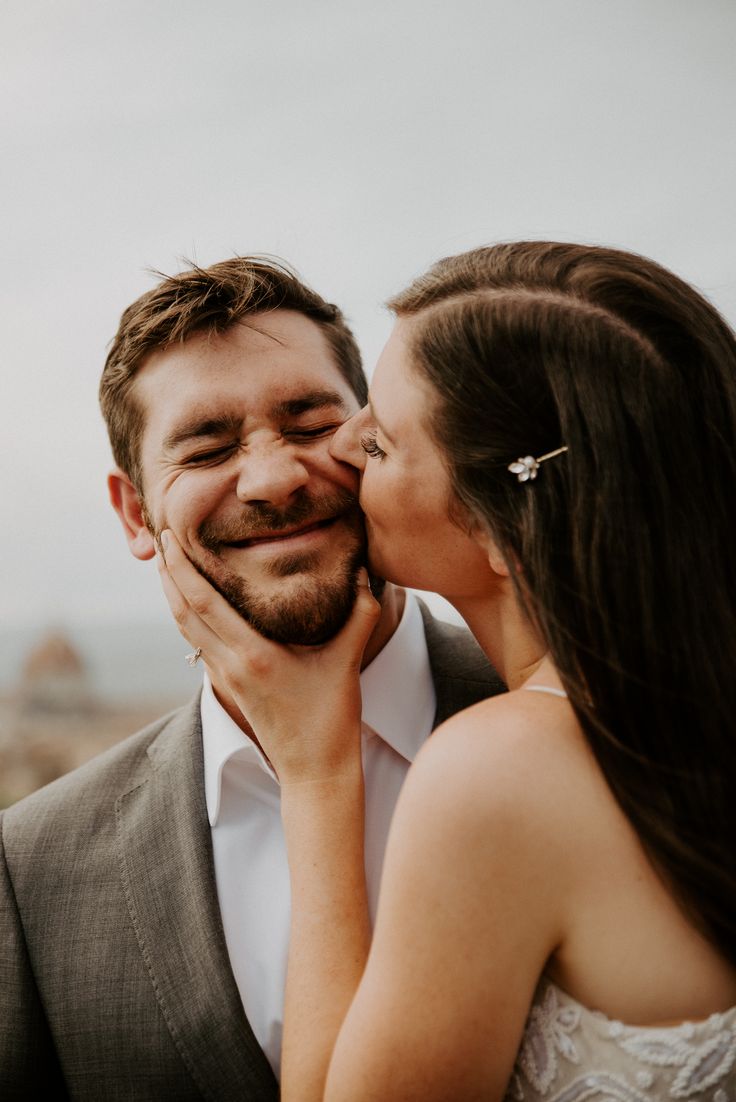 a man and woman are kissing each other