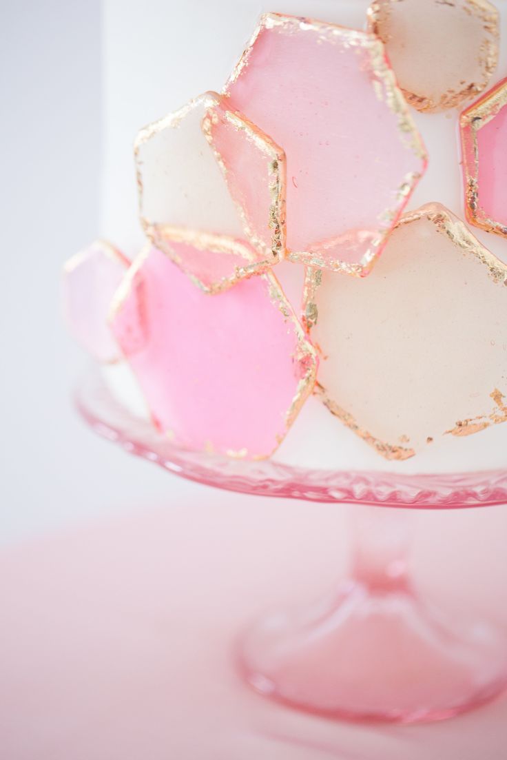 a close up of a cake with pink and white frosting