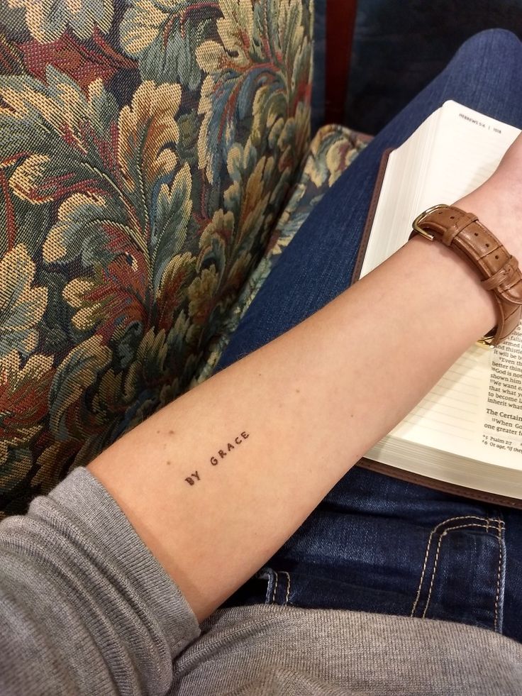 a person with a book on their arm