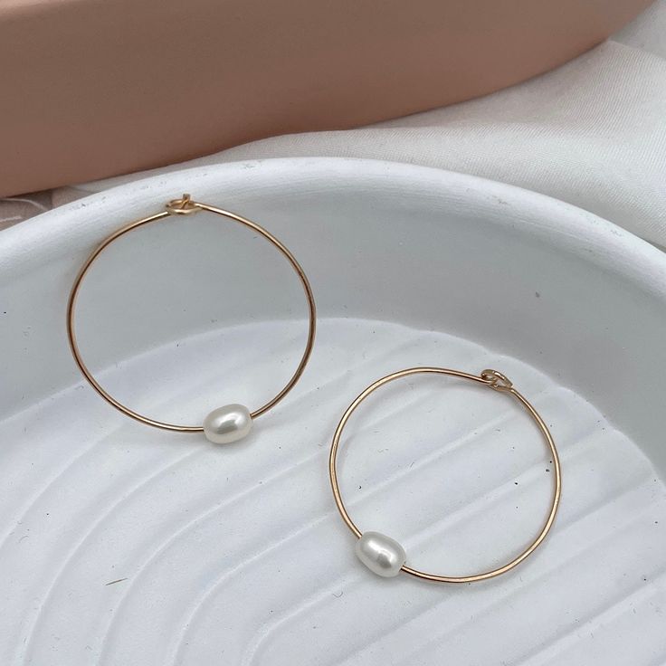 Hand-forged hoops featuring a single freshwater pearl are the perfect everyday accessory. Simple, clean, classic lines you'll never want to take off. Hand-made in our studio. These super lightweight hoop earrings are made of sterling silver or 14kt gold fill wire. Approximately 1 1/4 inch diameter. Small Pearl Hoop Earrings For Everyday, Minimalist Round Pearl Earrings, Everyday Small Hoop Earrings Wire Wrapped, Everyday Small Pearl Hoop Earrings, Minimalist Wire Wrapped Round Hoop Earrings, Minimalist 14k Gold Filled Small Hoop Pearl Earrings, Minimalist 14k Gold Filled Round Pearl Earrings, Minimalist Hoop Earrings With Pearl Drop, Minimalist Everyday Hoop Pearl Earrings