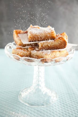 powdered sugar sprinkles on top of pastries in a glass dish