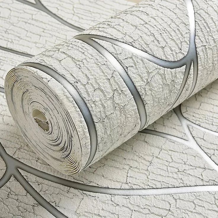 a roll of wallpaper with silver lines on the top and bottom, in front of a white background