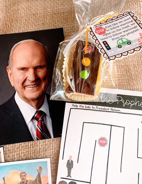 a table topped with pictures and cookies on top of a cloth covered table next to a card