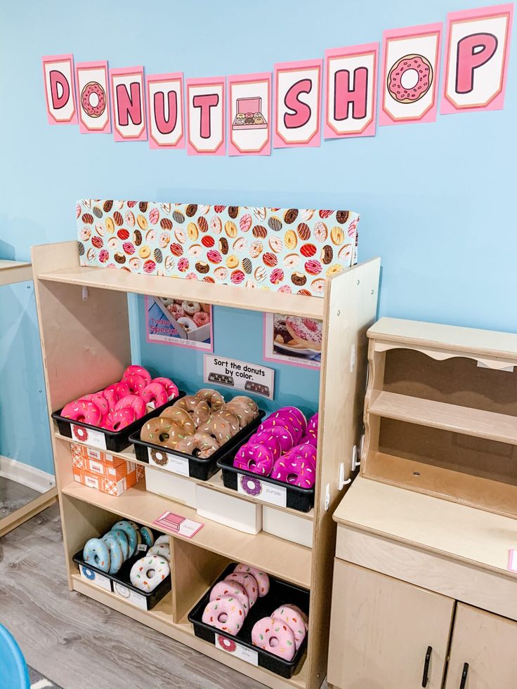 a donut shop display filled with doughnuts and pastries in bins