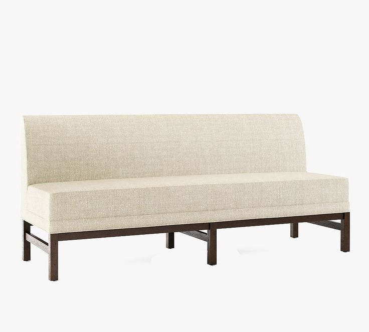 a white couch sitting on top of a wooden frame