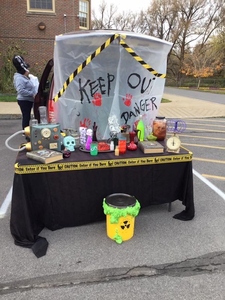 a table that has been set up with various items on it, including a sign saying keep out danger