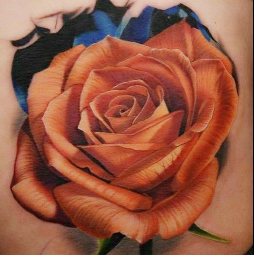 a rose tattoo on the back of a woman's shoulder