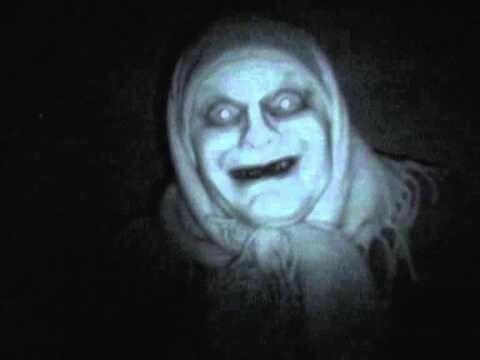 a creepy looking person wearing a hood in the dark