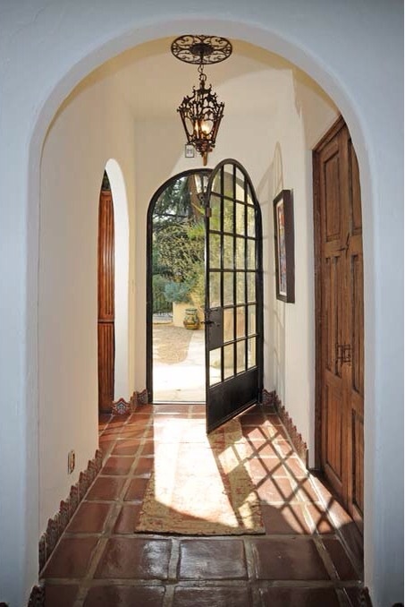 an arched doorway leading into a home