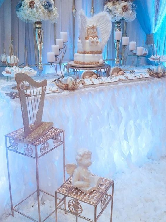 an elaborately decorated table with two chairs and a cake on the top is surrounded by candles