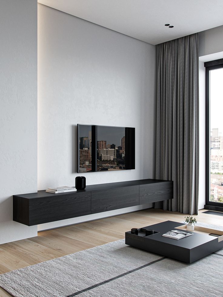 a living room with a large tv on the wall and a coffee table in front of it