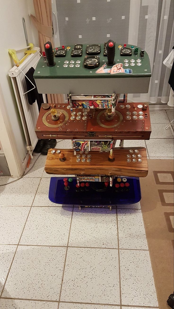 three different types of electronic devices sitting on top of each other in a room with tile flooring