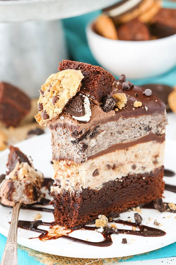 a piece of cake on a plate with chocolate and oreo cookies