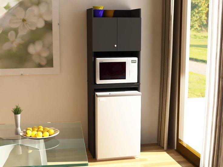 a microwave oven sitting on top of a counter next to a glass table with food