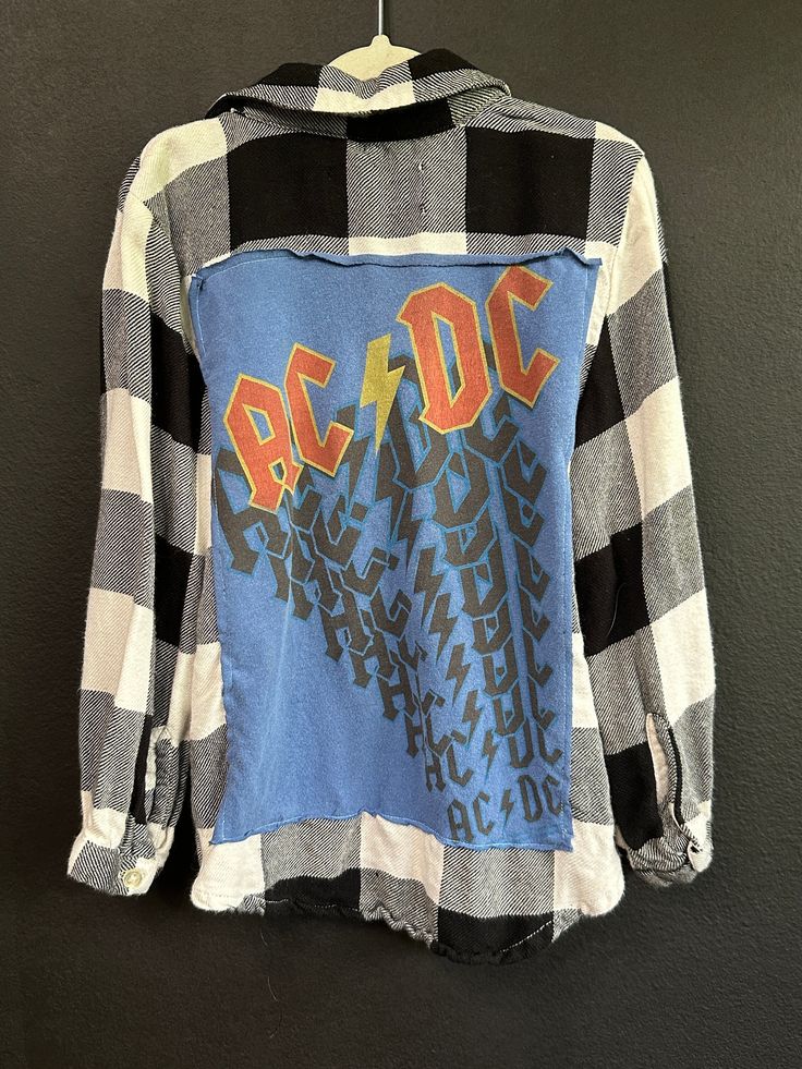 AC DC Flannel shirt. Perfectly imperfect! KIDS 5 for more specific sizing information reach out and I will measure! Plaid Long Sleeve Grunge Tops, Blue Grunge Top For Fall, Distressed Cotton Collared Tops, Distressed Collared Cotton Top, Grunge Cotton Shirt For Fall, Long Sleeve Flannel Top With Graphic Print, Plaid Cotton Tops With Letter Print, Plaid Graphic Print Long Sleeve Shirt, Casual Flannel Shirt With Graphic Print