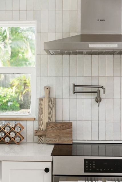 a stove top oven sitting inside of a kitchen