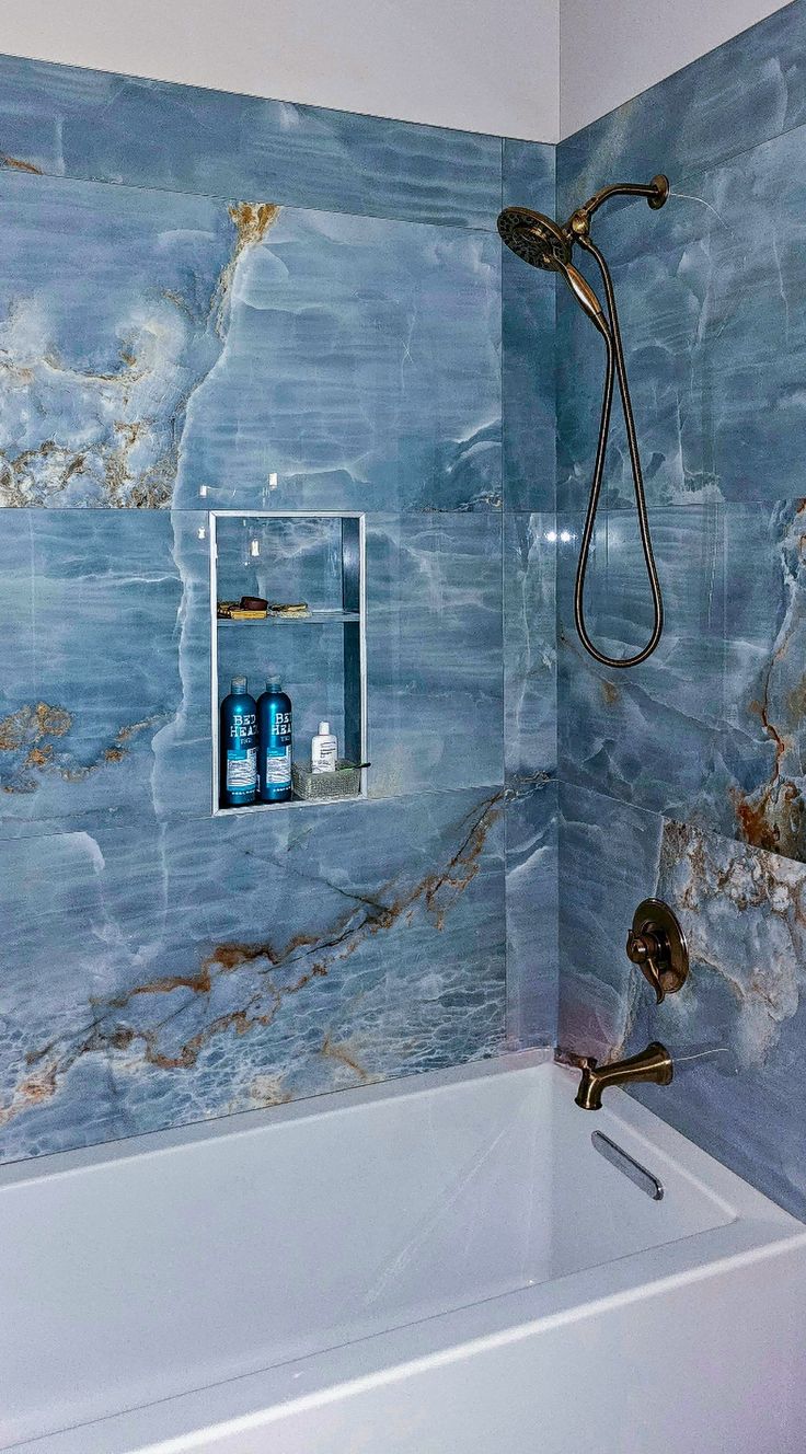 a bath tub sitting next to a shower head