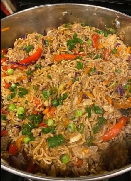 a large pot filled with noodles and vegetables