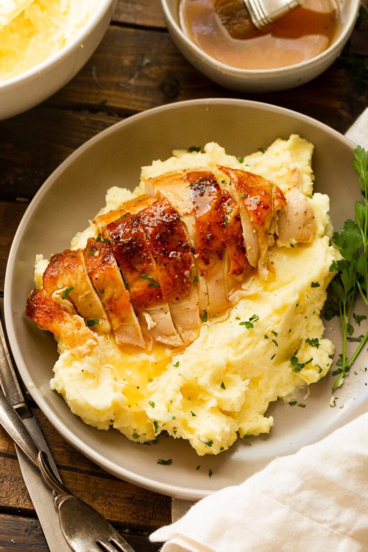 a white plate topped with mashed potatoes and chicken