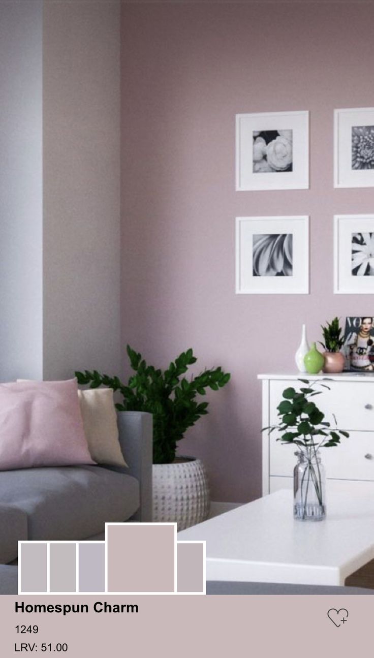 a living room filled with furniture and pictures on the wall next to a coffee table