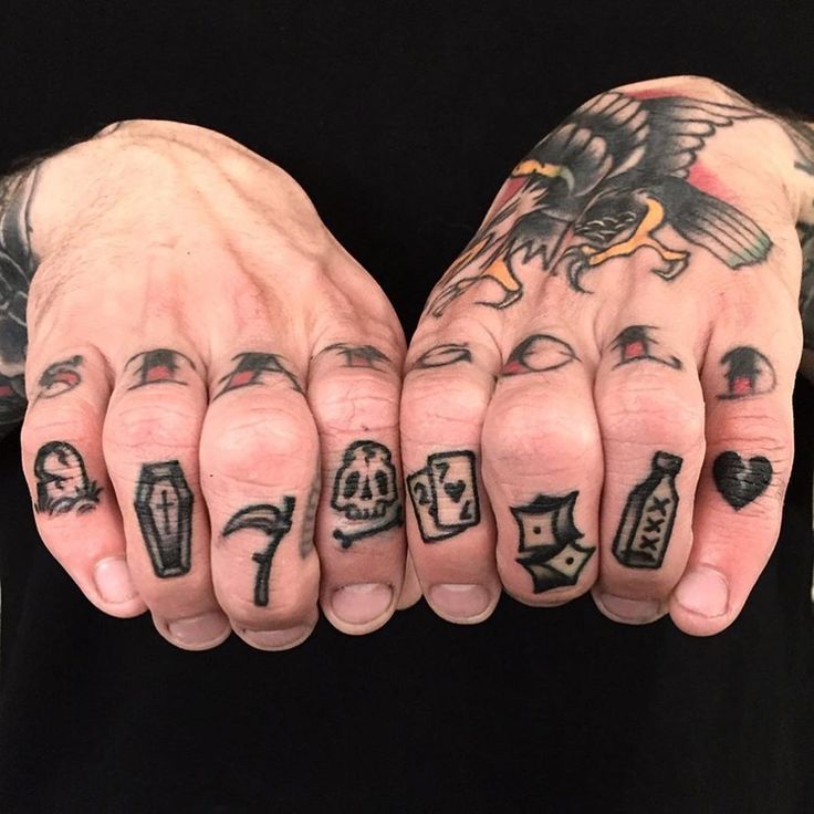 a person with tattoos on their hands and fingers