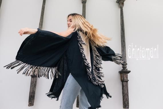 #clothing #women'sclothing #sweaters #linenclothingwomen #kimonojacket #kimonocardigan #fringejacket #bohorobe #fringerobe #linenkimono #bohoclothingwomen #fringedress #widesleevetop #tribalcardigan #kimonowraptop #blackkimono #chintamani #chintamanialchemistry Black Shawl Outerwear For Festival, Black Fringe Cardigan For Spring, Black Long Sleeve Summer Shrug, Black Bohemian Cardigan For Summer, Black Bohemian Summer Cardigan, Chic Black Beach Cardigan, Chic Fringe Outerwear For Festivals, Black Fringe Long Sleeve Cardigan, Black Long Sleeve Fringe Cardigan