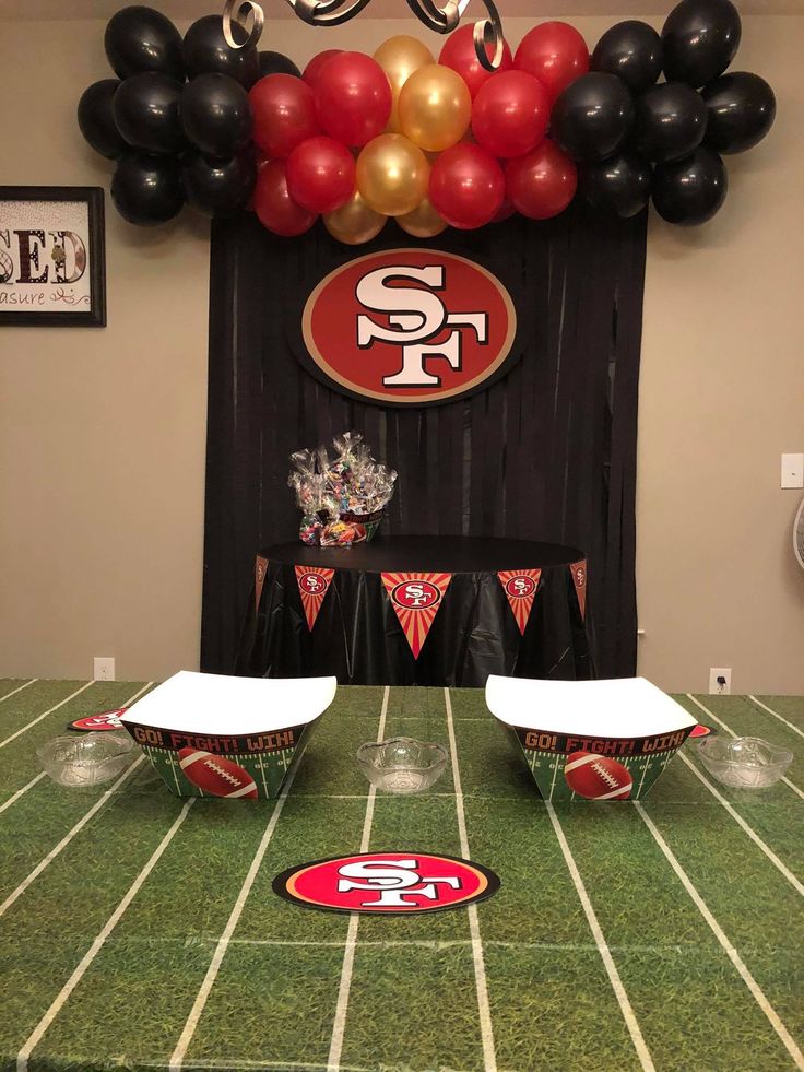 a football field with balloons and decorations on the sidelines for a sports themed birthday party