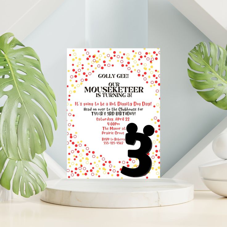 a birthday party card with the number 3 on it and a plant in the background