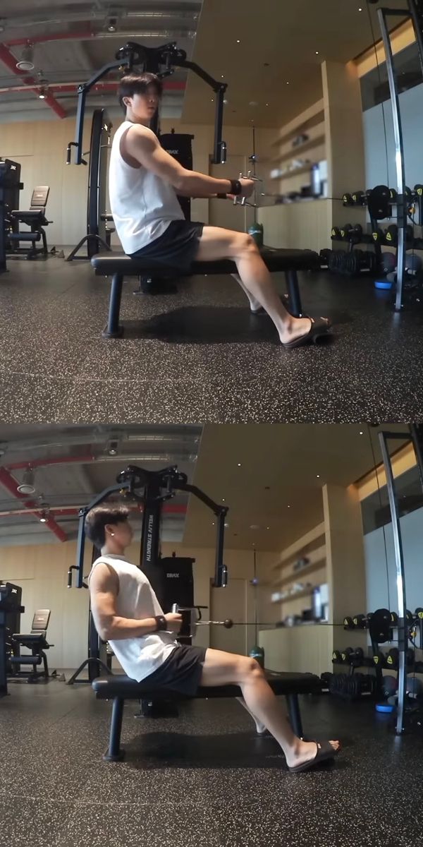 a man sitting on top of a bench in a gym