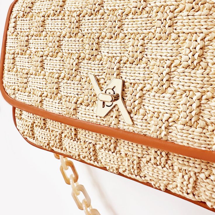 Expertly crafted from supple raffia, its design blends a structured frame and the YLIANA YEPEZ wow effect. Wear it as a hobo with its round top handle or as a cross-body bag using its chain strap. Italian Raphia Gold hardware Custom YY turn lock Resin chain body strap, 13'' (33 cm) Drop Top handle 5.5" (14 cm) Drop Internal zipped pocket Internal YY logo plaque Fabric lining Height: 5'' (12,7cm) Width: 7.5'' (19cm) Depth: 2.15'' (5,4cm) 100% Made in Italy. Cleaning and Care Our products are made Beige Straw Bag With Woven Leather Top Handle, Woven Jute Shoulder Bag With Top Handle, Beige Rattan Shoulder Bag With Adjustable Strap, Jute Woven Top Handle Shoulder Bag, Top Handle Woven Jute Shoulder Bag, Beige Crossbody Straw Bag With Bamboo Handle, Top Handle Jute Shoulder Bag With Woven Details, Beige Crochet Bag With Woven Leather Top Handle, Natural Straw Bag With Detachable Strap For Everyday