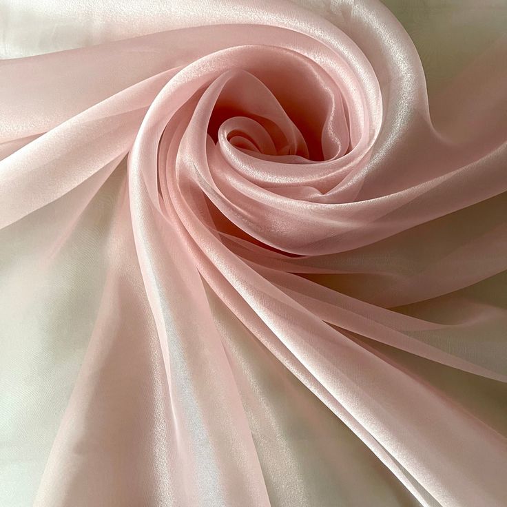 a close up view of a pink satin fabric